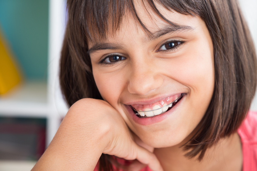 Portrait of a cute girl smiling wearing a removable orthodontic appliance