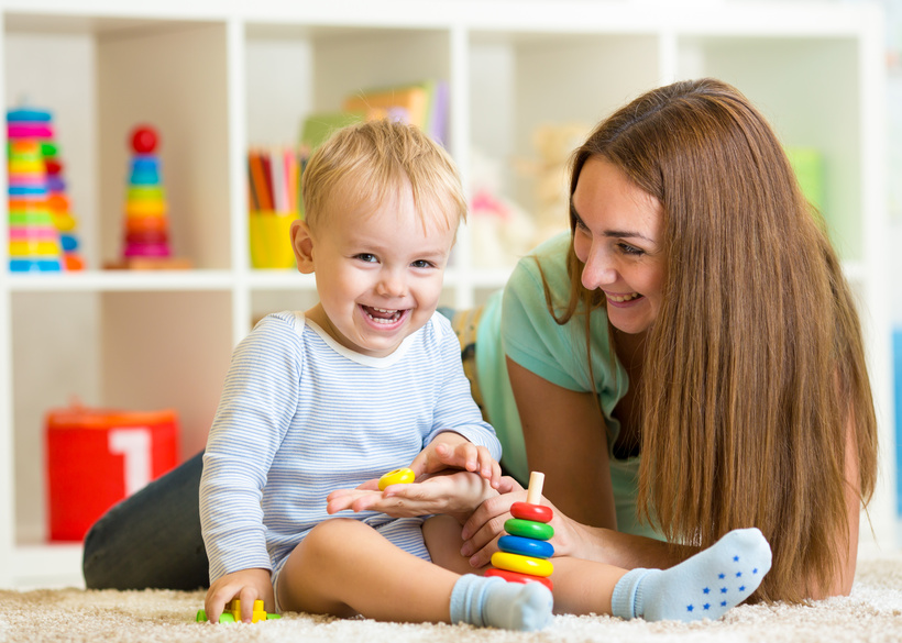 happy mother and child son playing together indoor at home
